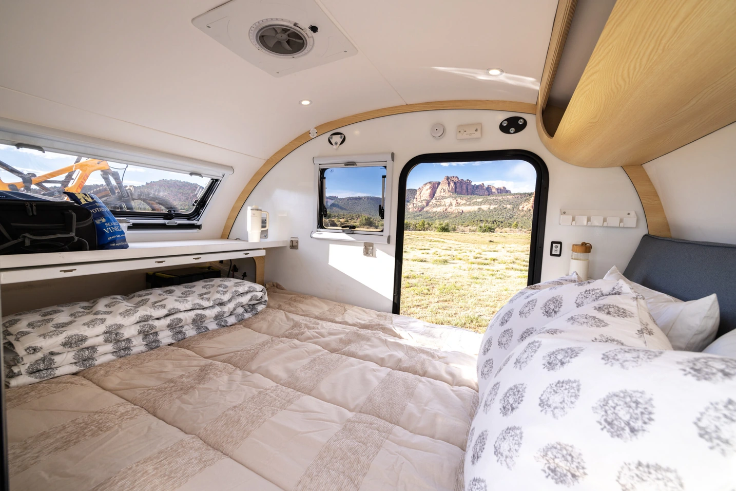 Spacious modern Bean Trailer interior with the rear hatch open to a forest